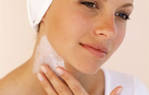 applying cream to rejuvenate the skin of the neck and décolleté